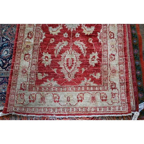1072 - A contemporary Agra runner, soft red stylized floral design on pink and camel ground, 635 x 80 cm&nb... 
