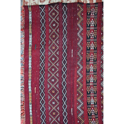 1074 - An old Persian Sumak flat weave carpet, the earth red ground  with multiple geometric design stripes... 