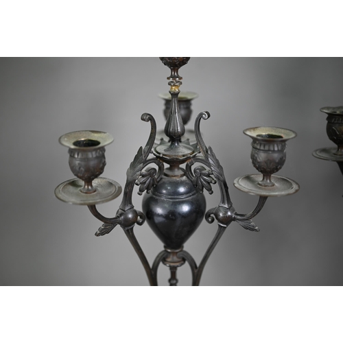 1080 - A pair of antique bronze patinated four branch candelabra, on tri-form bases and marble plinths, 54 ... 