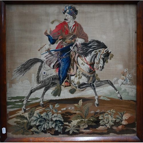 1146 - A 19th century needlework picture of an Ottoman cavalryman, 55 cm square, in glazed rosewood frame