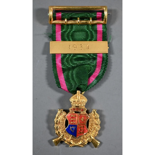 1161 - A 9ct gold and enamelled Rifle Association medal, the ribbon with 1934 bar and buckle pin, in fitted... 