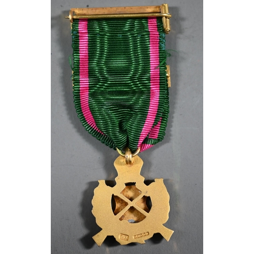 1161 - A 9ct gold and enamelled Rifle Association medal, the ribbon with 1934 bar and buckle pin, in fitted... 