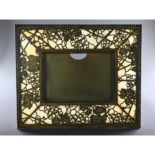 1209 - Tiffany Studios, New York, a gilt brass and mottled opaque glass panelled strut frame in the pine ne... 