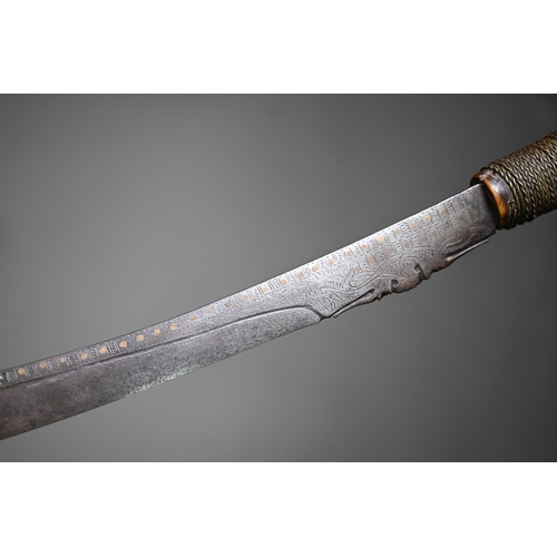 1310 - A Dyak sword, Mandu, the blade with brass inlay and pierced decoration to edge, the carved bone hilt... 