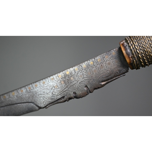 1310 - A Dyak sword, Mandu, the blade with brass inlay and pierced decoration to edge, the carved bone hilt... 