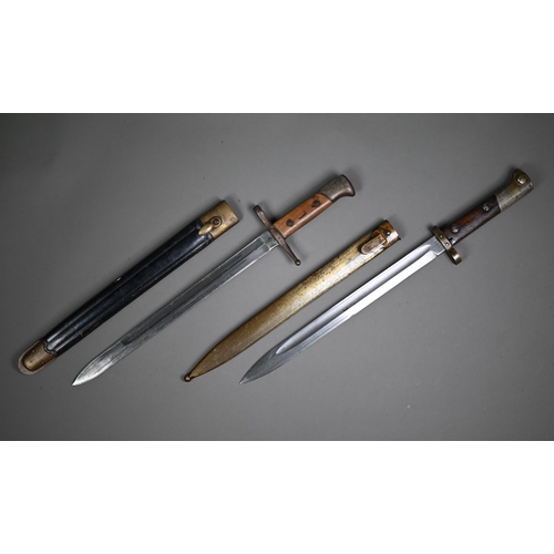 1308 - An E26 bayonet, the sngle fuller blade with wood grip, in steel scabbard to/w another bayonet and sc... 