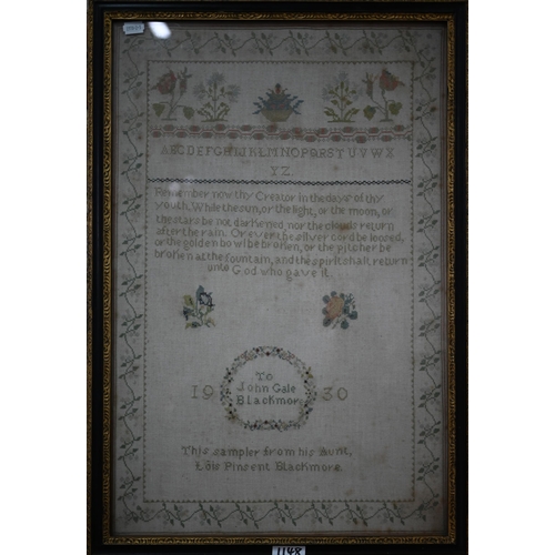 1148 - A 19th century cross-stitch needlework sampler worked with alphabet and numbers and baskets of flowe... 