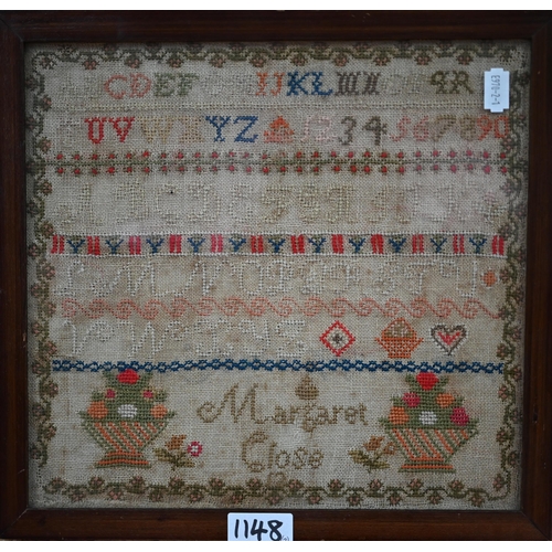 1148 - A 19th century cross-stitch needlework sampler worked with alphabet and numbers and baskets of flowe... 