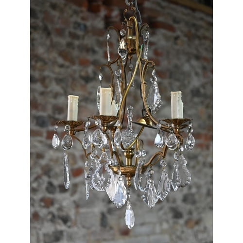 1026 - A gilt brass and crystal glass hung five branch electrolier, approx. 40 cm dia. x 60 cm h