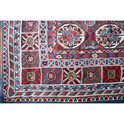 1097 - A North Indian Kashmiri Turkoman design chain-stitched rug or wall hanging, embroidered in coloured ... 