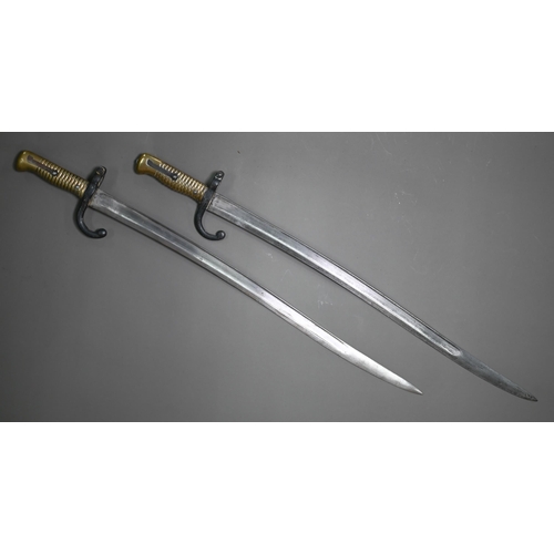 1316 - Two 19th century French sabre bayonets, with 57.5 cm curving blades, one marked St Etienne 1869, the... 