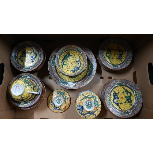 560A - A 1930's Chinese yellow ground tea and coffee service painted in polychrome enamels with dragons dis... 