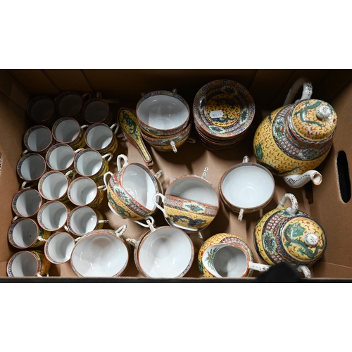 560A - A 1930's Chinese yellow ground tea and coffee service painted in polychrome enamels with dragons dis... 