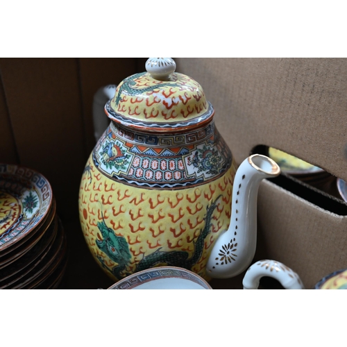 560A - A 1930's Chinese yellow ground tea and coffee service painted in polychrome enamels with dragons dis... 