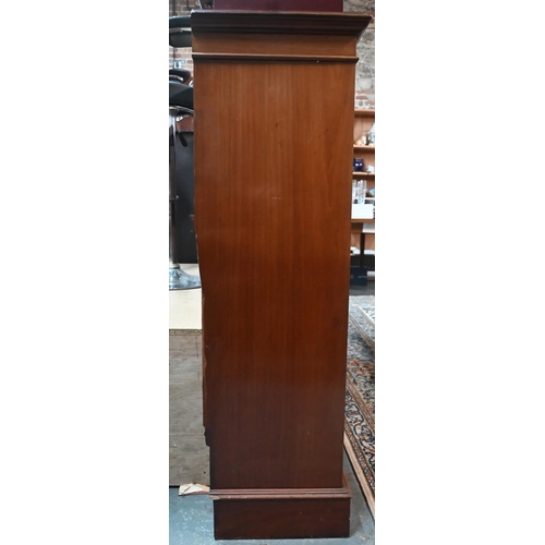 900 - A Victorian mahogany low open bookcase, centred by two long drawers over an open niche and pair cupb... 