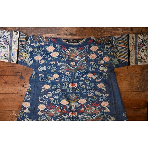 593 - A Chinese blue gauze brocade-woven dragon robe, late Qing period, woven design with nine dragons amo... 