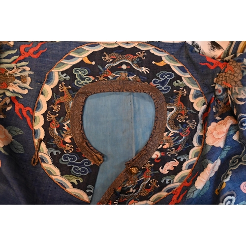 593 - A Chinese blue gauze brocade-woven dragon robe, late Qing period, woven design with nine dragons amo... 