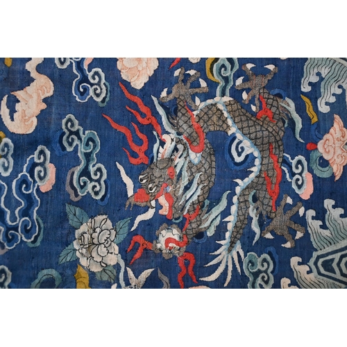 593 - A Chinese blue gauze brocade-woven dragon robe, late Qing period, woven design with nine dragons amo... 