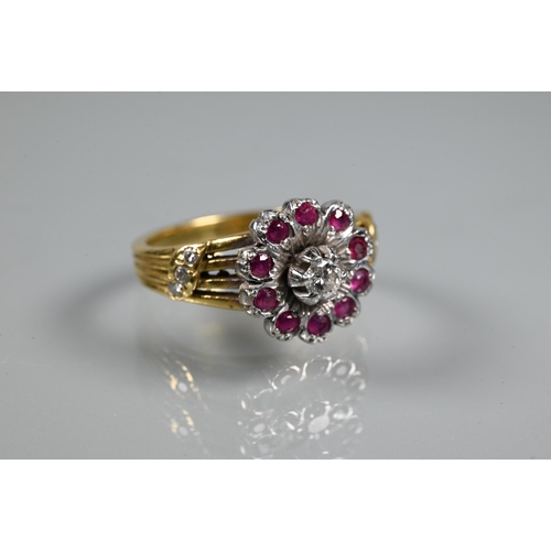 380 - A diamond and ruby cluster ring, the cluster in the form of petals set with central diamond surround... 