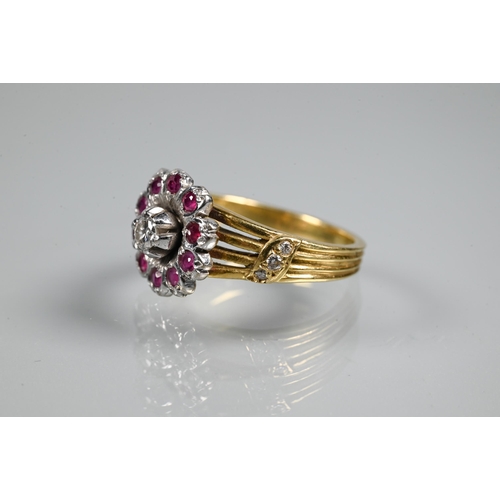 380 - A diamond and ruby cluster ring, the cluster in the form of petals set with central diamond surround... 
