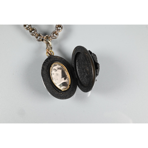 427 - A Victorian Whitby jet oval locket with cameo carved in high relief to front, and opening to reveal ... 