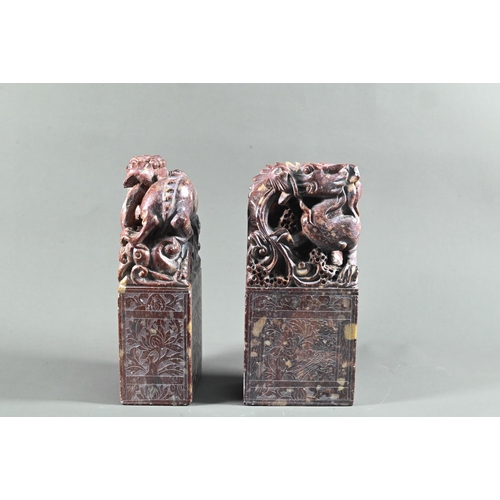 548 - A pair of early 20th century Chinese carved and engraved soapstone bookends, red stone with buff inc... 