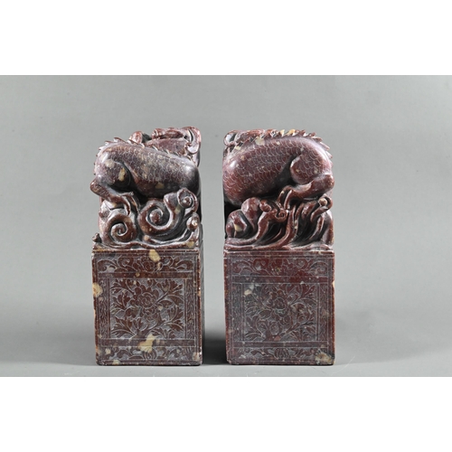 548 - A pair of early 20th century Chinese carved and engraved soapstone bookends, red stone with buff inc... 