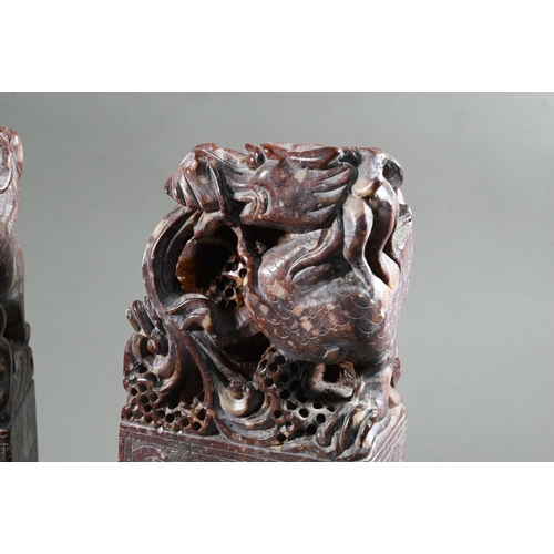 548 - A pair of early 20th century Chinese carved and engraved soapstone bookends, red stone with buff inc... 