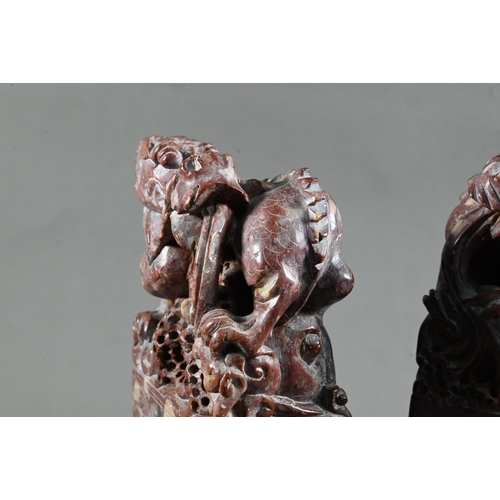 548 - A pair of early 20th century Chinese carved and engraved soapstone bookends, red stone with buff inc... 