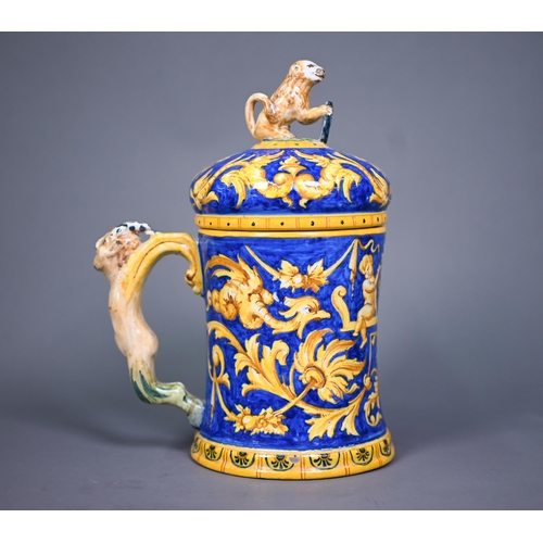 644 - A Venetian maiolica tankard & cover, painted with grotesques and putti in ochre and yellow on a ... 