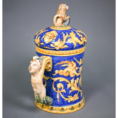 644 - A Venetian maiolica tankard & cover, painted with grotesques and putti in ochre and yellow on a ... 