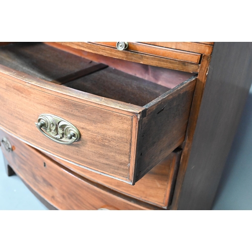 928 - A Victorian mahogany bow-fronted chest of three drawers beneath a full width slide, raised on shaped... 