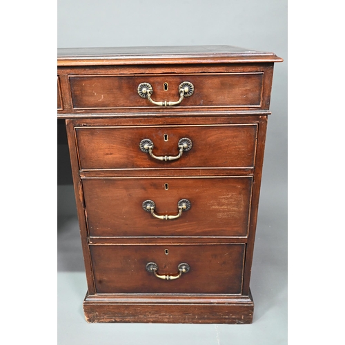 956 - An antique mahogany twin pedestal desk, the leathercloth inset top over an arrangement of nine drawe... 