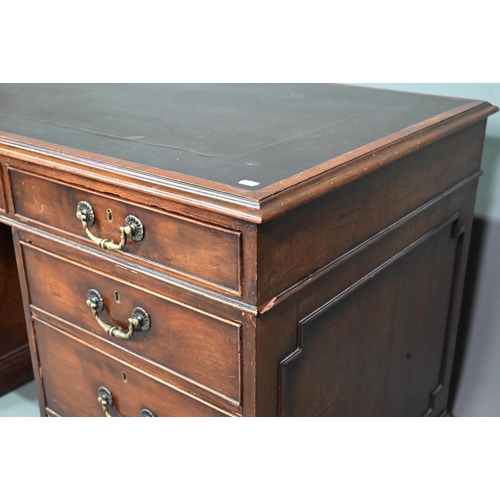 956 - An antique mahogany twin pedestal desk, the leathercloth inset top over an arrangement of nine drawe... 