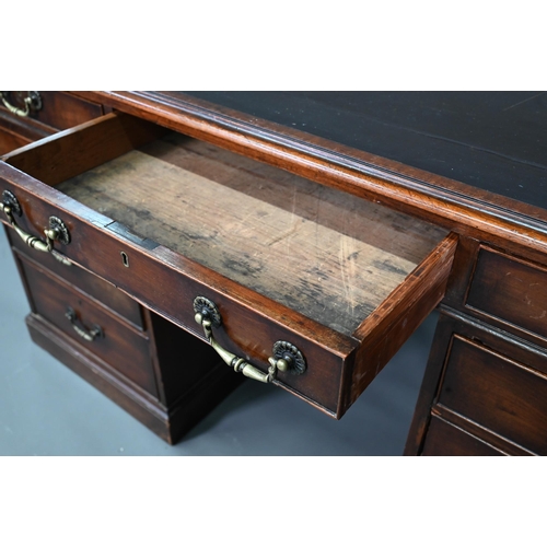 956 - An antique mahogany twin pedestal desk, the leathercloth inset top over an arrangement of nine drawe... 