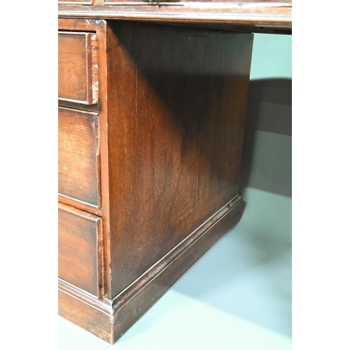 956 - An antique mahogany twin pedestal desk, the leathercloth inset top over an arrangement of nine drawe... 