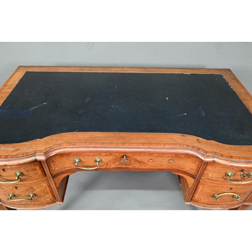 994 - A late 19th century cross-banded satinwood desk, the top with leather surface over five drawers, rai... 