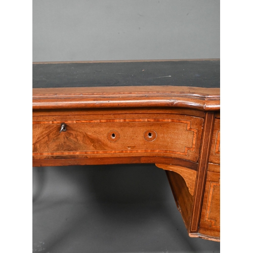 994 - A late 19th century cross-banded satinwood desk, the top with leather surface over five drawers, rai... 