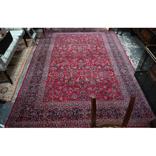 1061 - A fine old Persian hand-made Kashan carpet, the red ground with repeating linked garden vine design,... 