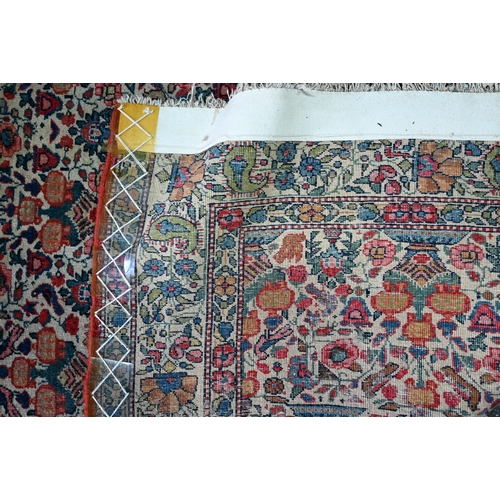 1068 - An antique Persian Qom rug, repeating floral vase design on camel ground, 220 cm x 138 cm