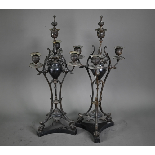 1080 - A pair of antique bronze patinated four branch candelabra, on tri-form bases and marble plinths, 54 ... 