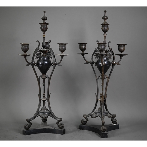 1080 - A pair of antique bronze patinated four branch candelabra, on tri-form bases and marble plinths, 54 ... 