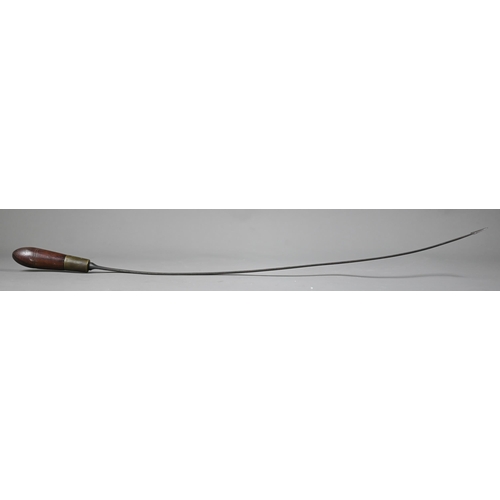 1283 - An antique weapon, the 60 cm curved steel blade with barbed finial, on brass-mounted rosewood hilt, ... 