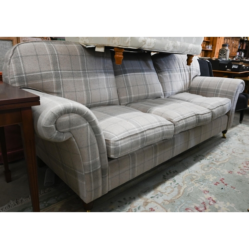 A Laura Ashely three seater sofa with straight back and scroll arms standing on turned legs with brass casters, grey/buff tartan tweed upholstery, 250 cm wide x 95 cm deep x 100cm high
