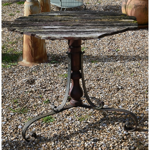 54 - An old wood slat top and wrought steel table, by repute ex Southampton pier?