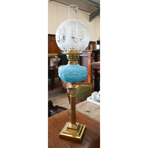 535 - A Victorian brass oil lamp with etched globe shade, blue pressed glass font and classical pillar, 72... 