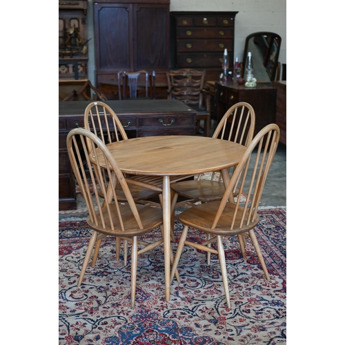 A mid-century Ercol Windsor elm and beech oval breakfast table with spindled undertier on splayed turned supports, 100 cm x 90 cm x 72 cm high (Ercol model 396) to/w set of four Ercol 'Quaker' dining chairs (Ercol model 365, blue label) circa 1960s