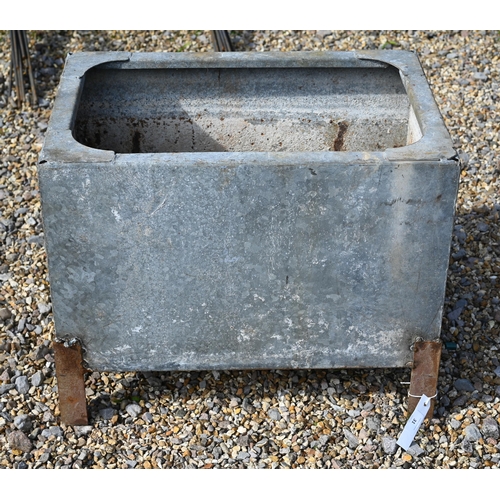 31 - A galvanised rivetted cistern, raised on welded feet
