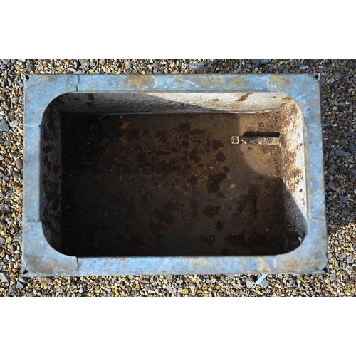 31 - A galvanised rivetted cistern, raised on welded feet