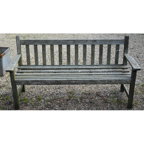48 - A weathered slatted teak three-seater garden bench, 160 cm wide